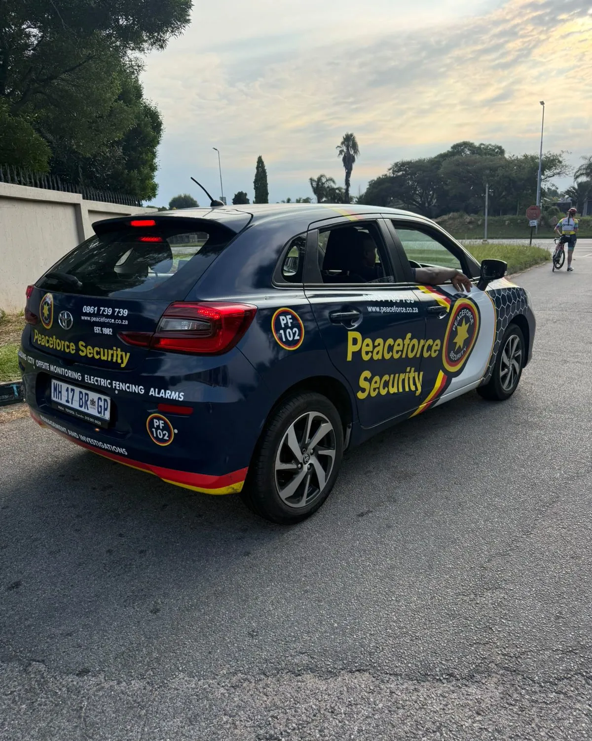 A Peaceforce Security branded follow car at Melrose Arch before a Sunday ride, with cyclists gathering nearby